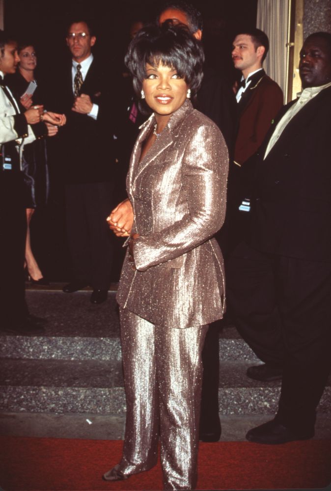 Oprah Winfrey in gold pant suit at the 23rd Daytime Emmy Awards photo print.