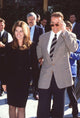 Maria Shriver in black skirt suit with Arnold Schwarzenegger photo print