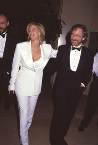 Steven Spielberg in tuxedo and Kate Capshaw in white pant suit laughing photo print.