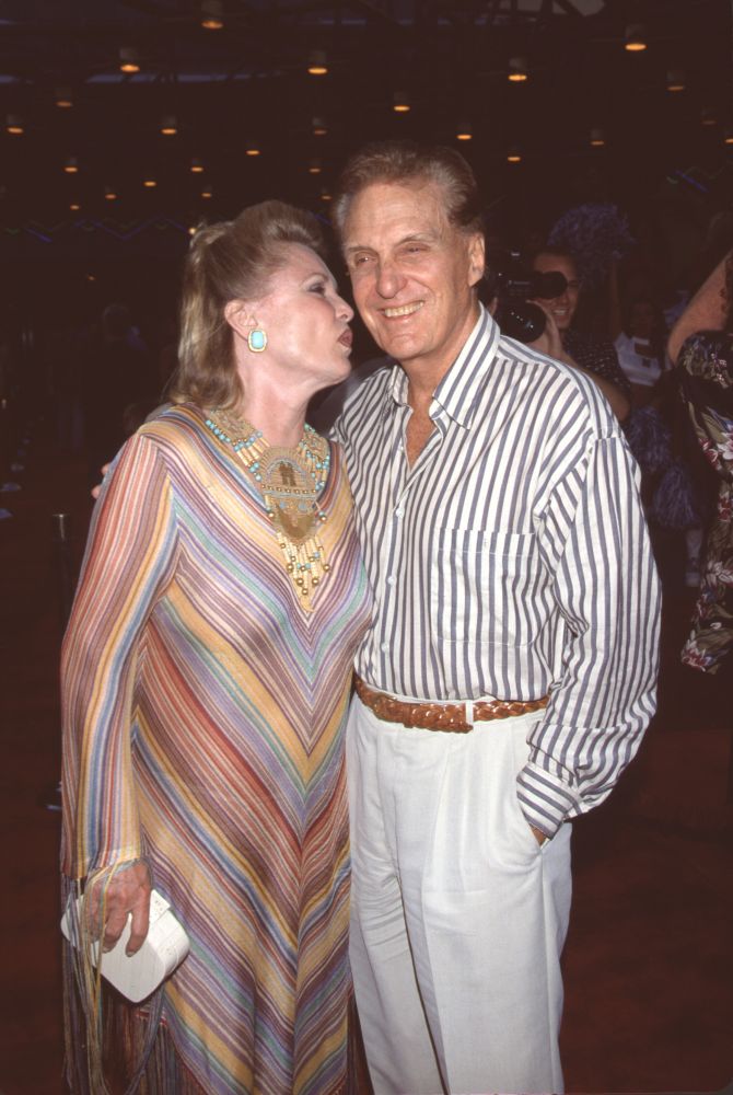 Robert Stack being kissed on the cheek by wife Rosemary photo print.
