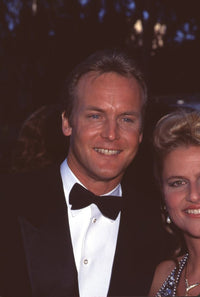 Doug Davidson in tuxedo next to a woman photo print.