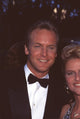 Doug Davidson in tuxedo next to a woman photo print.