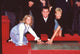 Jane Carrey and Lauren Holly pushing Jim Carrey's hands into cement photo print.