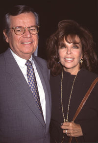Bob Daly in gray suit and Carole Bayer Sager in black outfit photo print.