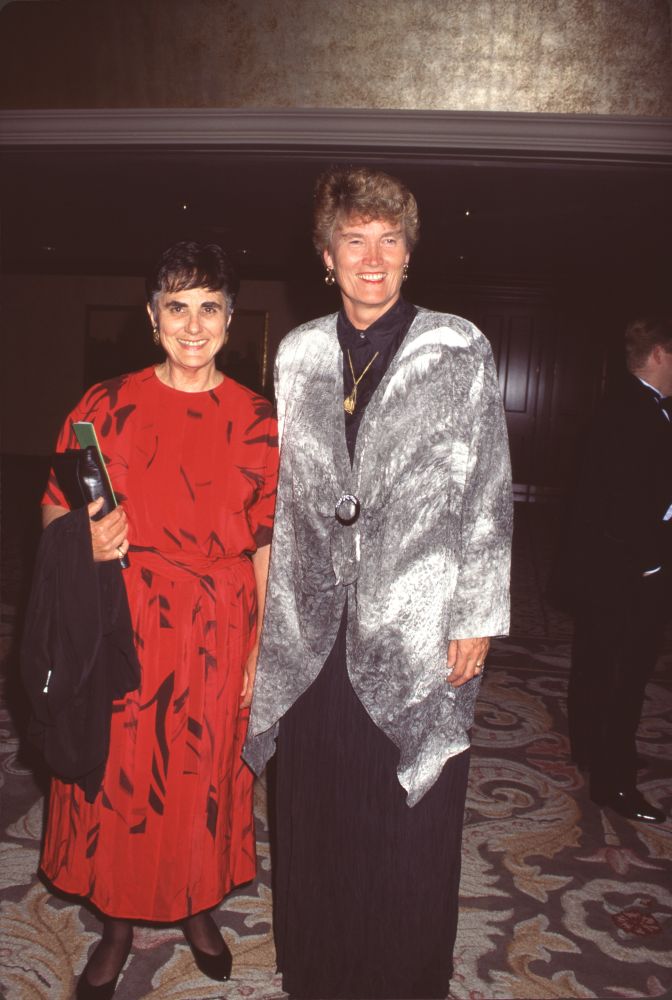 Diane Devilbiss in red and black dress with silver jacket photo print.