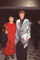 Diane Devilbiss in red and black dress with silver jacket photo print.