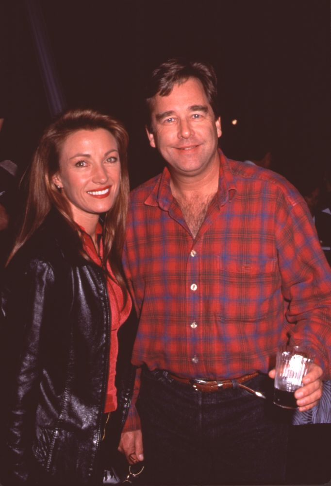 Jane Seymour in red top and leather jacket with Beau Bridges in plaid shirt at 101 Dalmatians party photo print