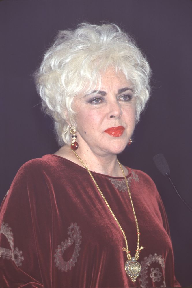 Elizabeth Taylor in dark red velvet with long gold necklace photo print.