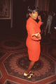 Oprah Winfrey in a red skirt suit at the Peabody Awards photo print.