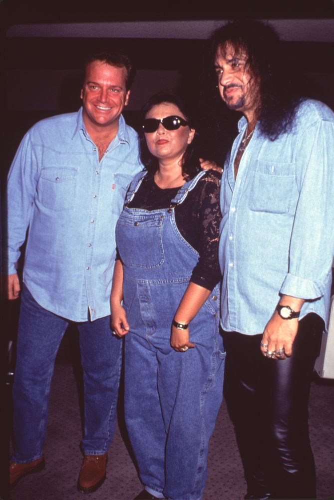 Photo print of Tom Arnold and Roseanne Arnold with Gene Simmons at his birthday party.