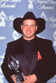 Garth Brooks holding award at 22nd People's Choice Awards photo print