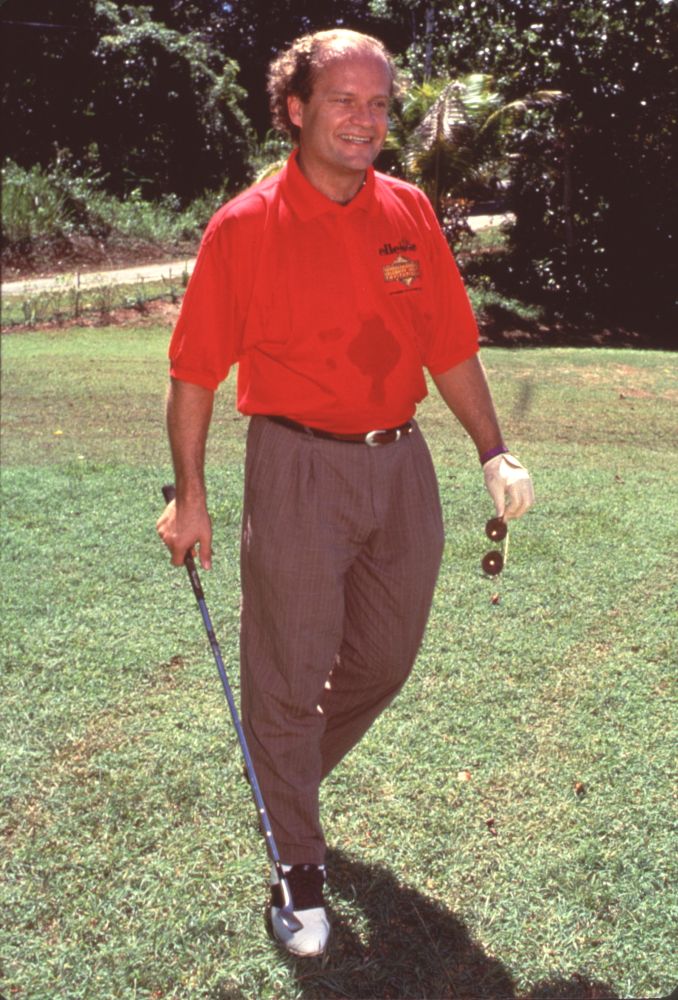 Kelsey Grammer golfing in a red polo and brown pants photo print