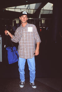 Luke Perry casual style photo print at LAX in jeans and plaid shirt.