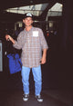 Luke Perry casual style photo print at LAX in jeans and plaid shirt.