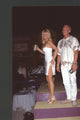 Nikki and Ian Ziering in white outfits standing on steps photo print.