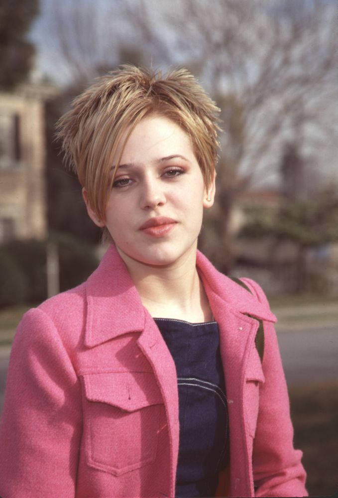 Majandra Delfino photo print in pink jacket with short hair.