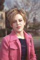 Majandra Delfino photo print in pink jacket with short hair.