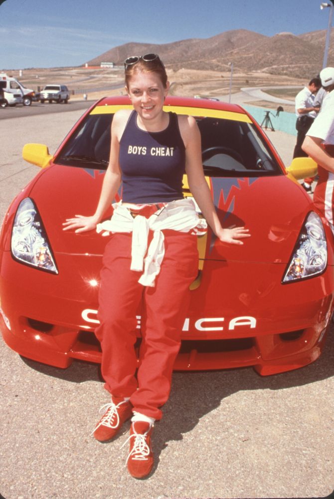 Melissa Joan Hart leaning on a Toyota during a celebrity race photo print.