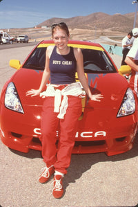 Melissa Joan Hart leaning on a Toyota during a celebrity race photo print.