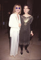 Jensen Buchanan in white outfit and sunglasses with Anna Stuart in gold and black outfit photo print.