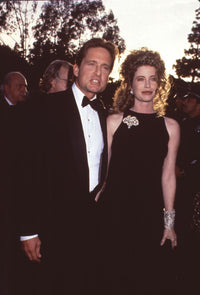 Michael Douglas in tuxedo with Diandra Luker in black dress and gold bangles photo print.