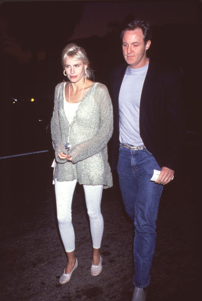 Daryl Hannah walking photo print in white outfit, stylish and elegant.