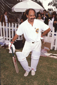 Cheech Marin leaning on a cricket bat photo print.