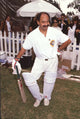 Cheech Marin leaning on a cricket bat photo print.