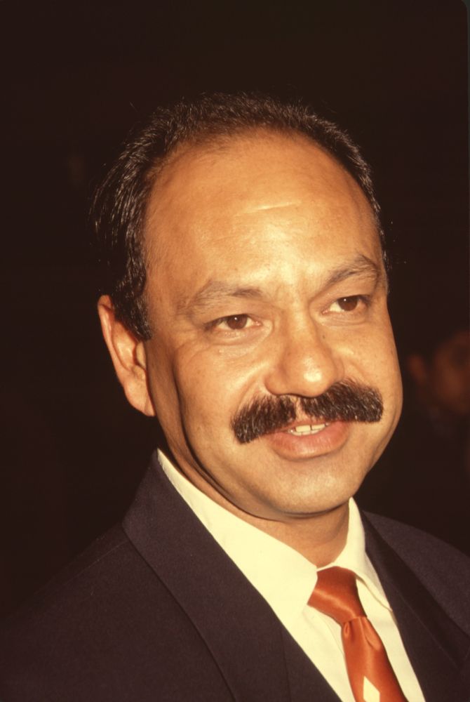 Cheech Marin closeup photo print in suit with orange tie.