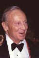 Closeup photo print of Norman Fell in tuxedo at Milton Berle's 85th birthday party.