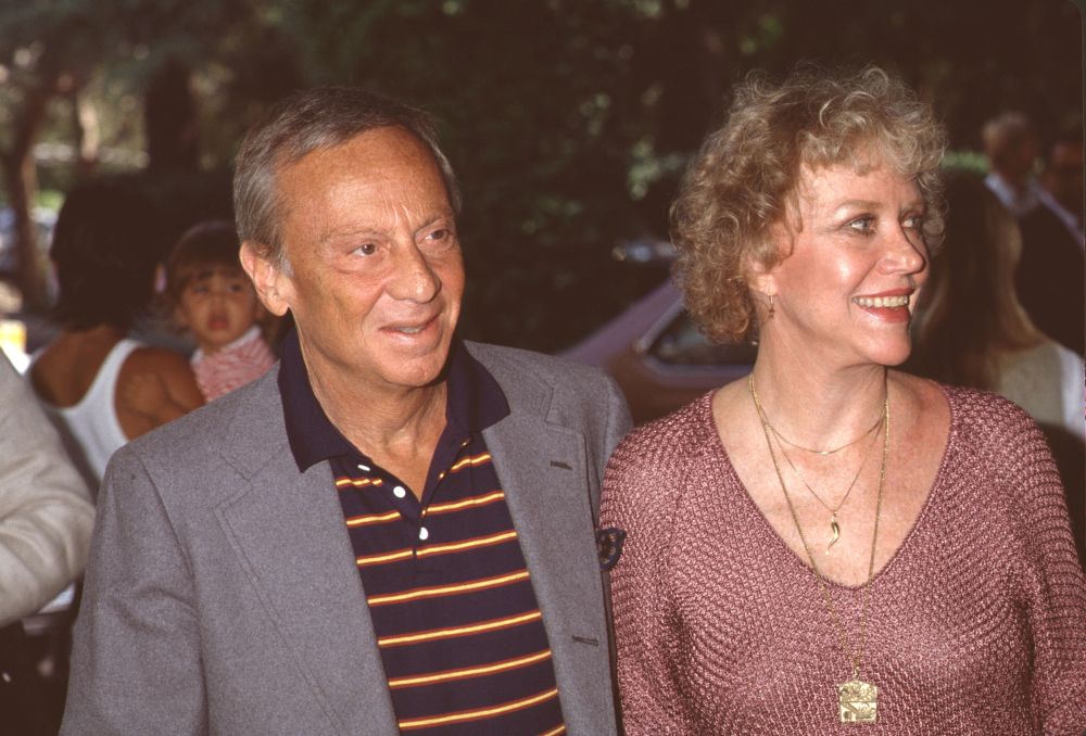 Norman Fell photo print in gray jacket with wife in pink top.