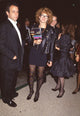 Melanie Mayron photo print in black dress and leather jacket with patterned tights.