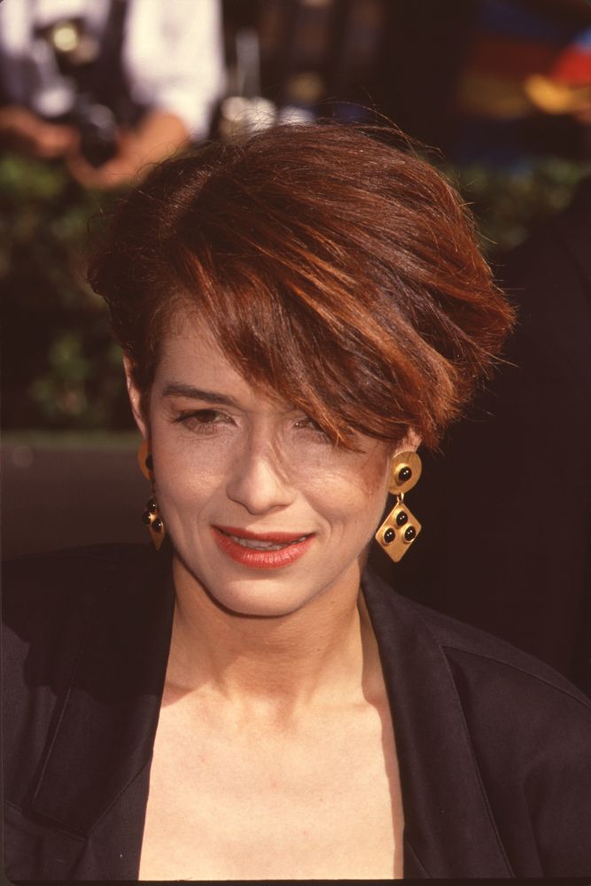 Melanie Mayron closeup photo print showcasing short hair and gold and black earrings.