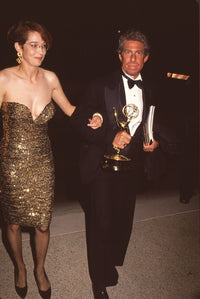 Melanie Mayron in gold strapless dress holding award photo print.
