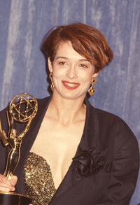 Melanie Mayron close-up photo print holding an award in a black jacket.