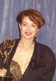 Melanie Mayron close-up photo print holding an award in a black jacket.