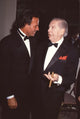 Julio Iglesias talking to Milton Berle with cigar photo print.