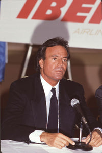 Julio Iglesias being interviewed sitting at a table photo print