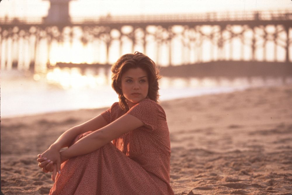 Susan Ward sitting on beach at sunset photo print