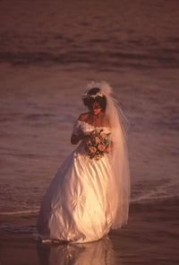 Susan Ward walking on the beach in a wedding dress photo print