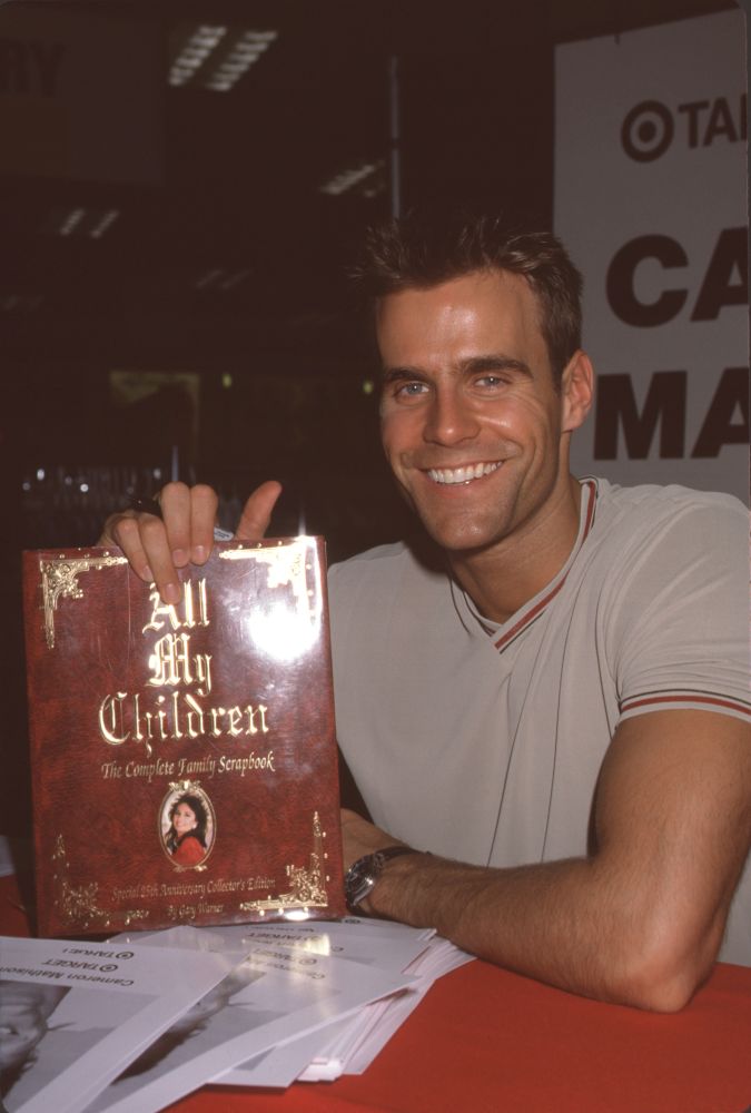 Cameron Mathison holding 'All My Children' book photo print