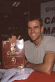 Cameron Mathison holding 'All My Children' book photo print