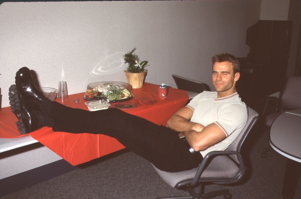 Cameron Mathison relaxing photo print with feet up on table.