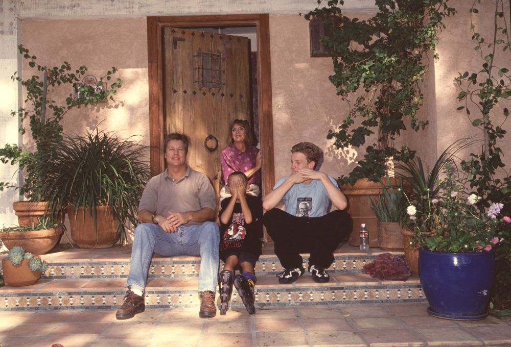 Brad Maule sitting on steps with his sons photo print