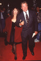 Marcy Lafferty in black dress with red coat holding hands with William Shatner photo print