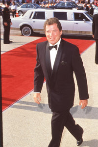 William Shatner walking on red carpet in tuxedo photo print.