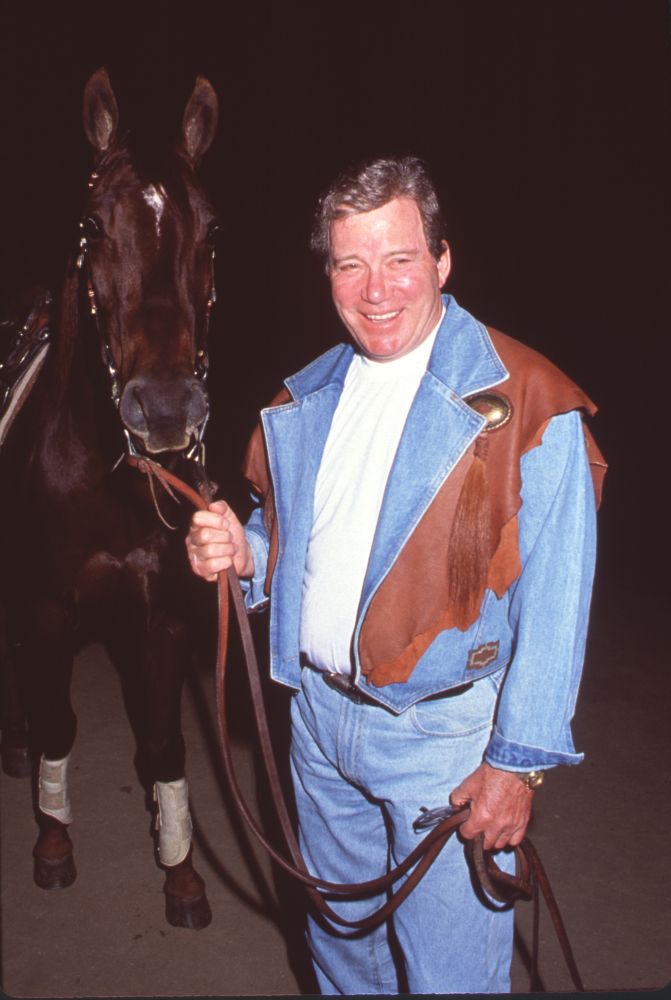 William Shatner photo print in denim outfit holding a horse