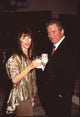 William Shatner in black suit with Marcy Lafferty in gold sheer top photo print