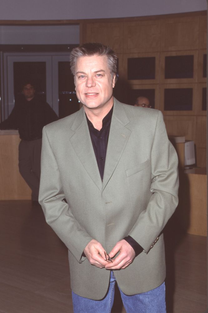 Photo print of Brad Maule in jeans, green jacket, and black shirt.