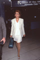 Sophia Loren walking through airport in elegant white suit photo print